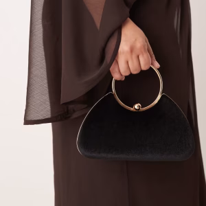 True Decadence velvet clutch bag with detachable crossbody strap in black and gold